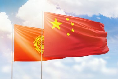 Sunny blue sky and flags of china and kyrgyzstan