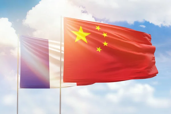 Sunny blue sky and flags of china and france