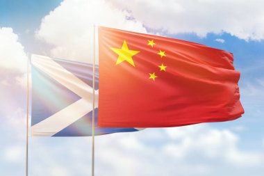 Sunny blue sky and flags of china and scotland