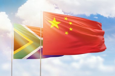 Sunny blue sky and flags of china and south africa