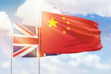 Sunny blue sky and flags of china and united kingdom