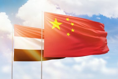 Sunny blue sky and flags of china and yemen