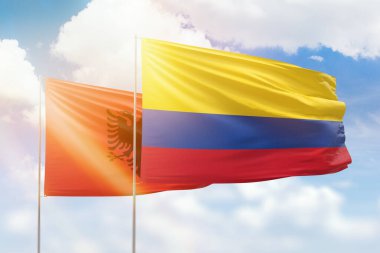 Sunny blue sky and flags of colombia and albania