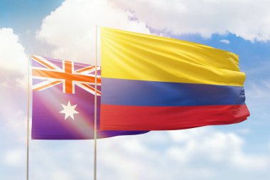 Sunny blue sky and flags of colombia and australia