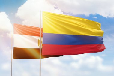 Sunny blue sky and flags of colombia and egypt