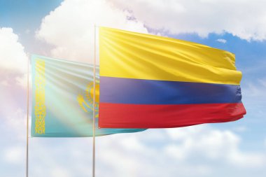 Sunny blue sky and flags of colombia and kazakhstan