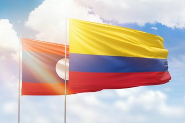 Sunny blue sky and flags of colombia and laos