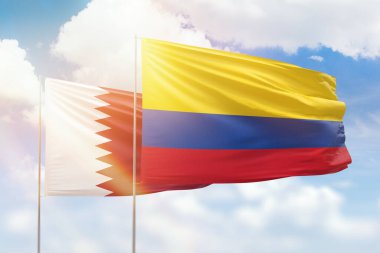 Sunny blue sky and flags of colombia and qatar