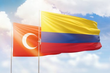 Sunny blue sky and flags of colombia and turkey