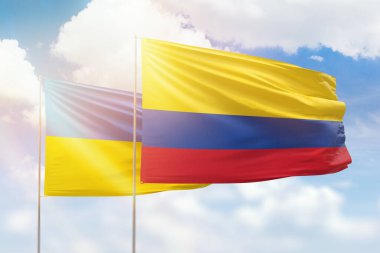 Sunny blue sky and flags of colombia and ukraine