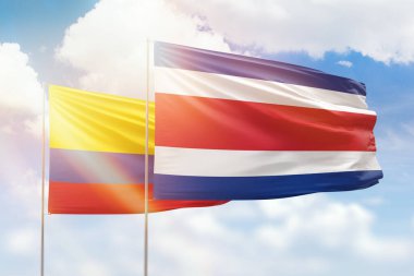 Sunny blue sky and flags of costa rica and colombia