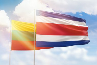 Sunny blue sky and flags of costa rica and lithuania