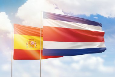 Sunny blue sky and flags of costa rica and spain