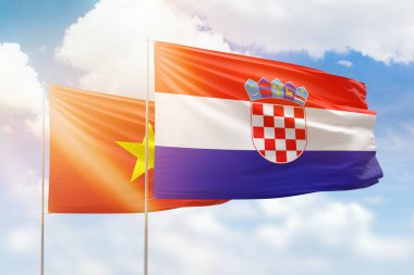 Sunny blue sky and flags of croatia and vietnam