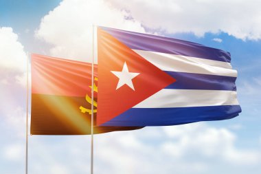 Sunny blue sky and flags of cuba and angola