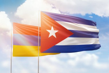 Sunny blue sky and flags of cuba and armenia