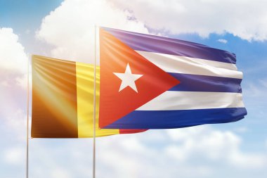 Sunny blue sky and flags of cuba and belgium