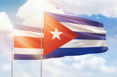 Sunny blue sky and flags of cuba and costa rica
