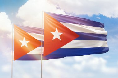Sunny blue sky and flags of cuba and cuba
