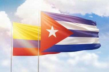 Sunny blue sky and flags of cuba and colombia