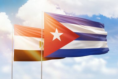 Sunny blue sky and flags of cuba and egypt