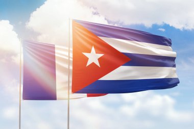 Sunny blue sky and flags of cuba and france