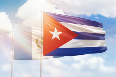 Sunny blue sky and flags of cuba and guatemala
