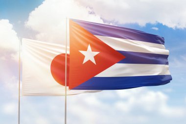 Sunny blue sky and flags of cuba and japan