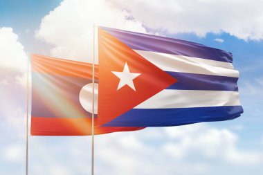 Sunny blue sky and flags of cuba and laos