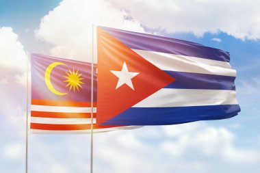 Sunny blue sky and flags of cuba and malaysia