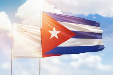 Sunny blue sky and flags of cuba and malta