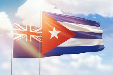 Sunny blue sky and flags of cuba and new zealand