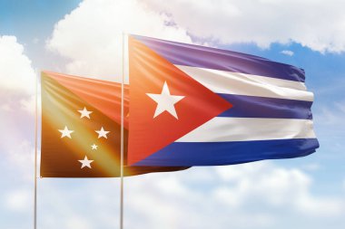 Sunny blue sky and flags of cuba and papua new guinea