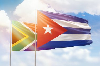 Sunny blue sky and flags of cuba and south africa
