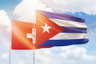 Sunny blue sky and flags of cuba and switzerland