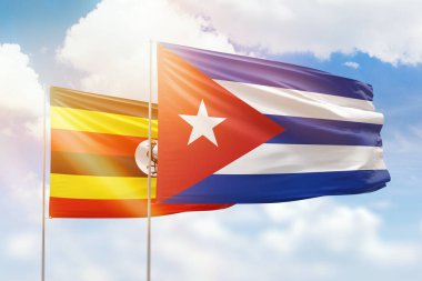 Sunny blue sky and flags of cuba and uganda