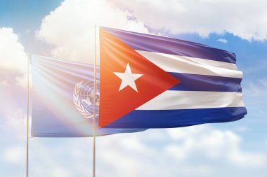 Sunny blue sky and flags of cuba and united nations