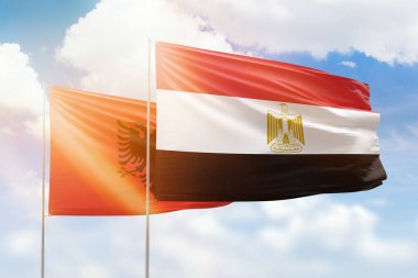 Sunny blue sky and flags of egypt and albania
