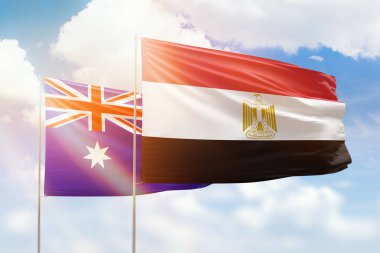 Sunny blue sky and flags of egypt and australia