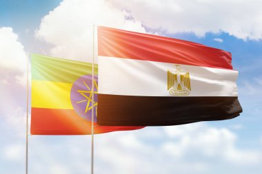 Sunny blue sky and flags of egypt and ethiopia