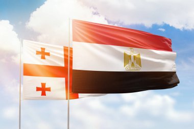 Sunny blue sky and flags of egypt and georgia