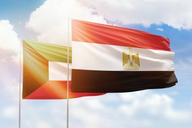 Sunny blue sky and flags of egypt and kuwait