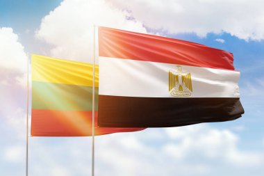 Sunny blue sky and flags of egypt and lithuania