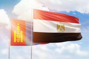 Sunny blue sky and flags of egypt and mongolia