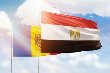 Sunny blue sky and flags of egypt and moldova