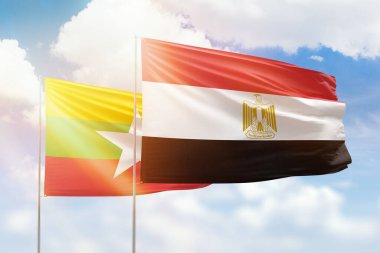 Sunny blue sky and flags of egypt and myanmar
