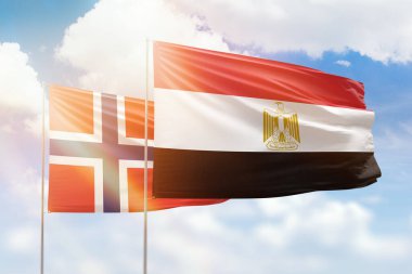 Sunny blue sky and flags of egypt and norway