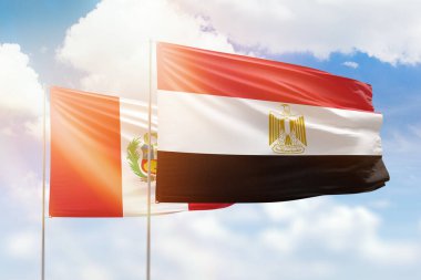 Sunny blue sky and flags of egypt and peru