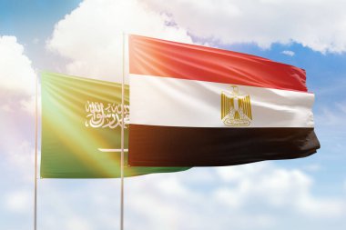 Sunny blue sky and flags of egypt and saudi arabia