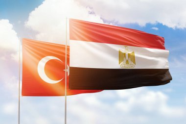 Sunny blue sky and flags of egypt and turkey